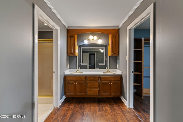 bathroom with ornamental molding, vanity, hardwood / wood-style floors, and an enclosed shower