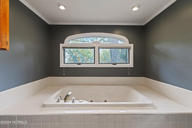 bathroom with ornamental molding and tiled bath