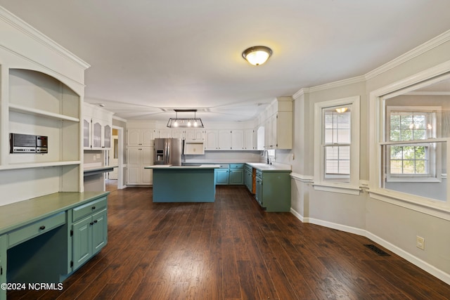 kitchen featuring ornamental molding, stainless steel fridge, dark hardwood / wood-style floors, and a kitchen island