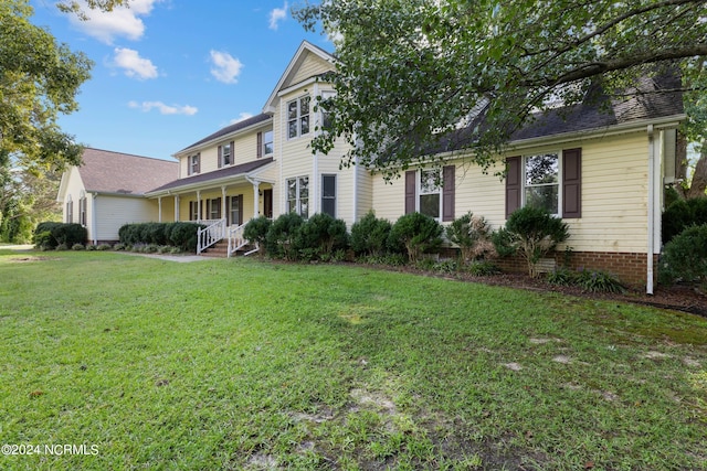 front facade with a front lawn and covered porch