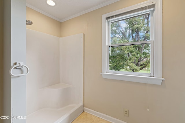 bathroom with walk in shower, crown molding, tile patterned flooring, and plenty of natural light