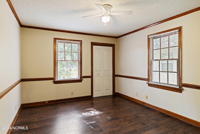 unfurnished room featuring a textured ceiling, crown molding, dark hardwood / wood-style flooring, and ceiling fan