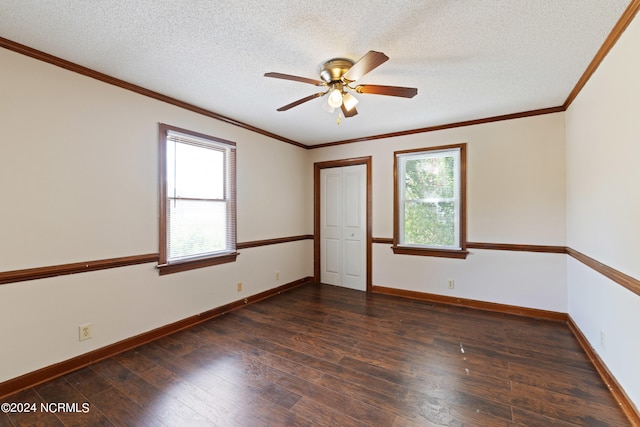 unfurnished room with ceiling fan, a textured ceiling, plenty of natural light, and dark hardwood / wood-style floors