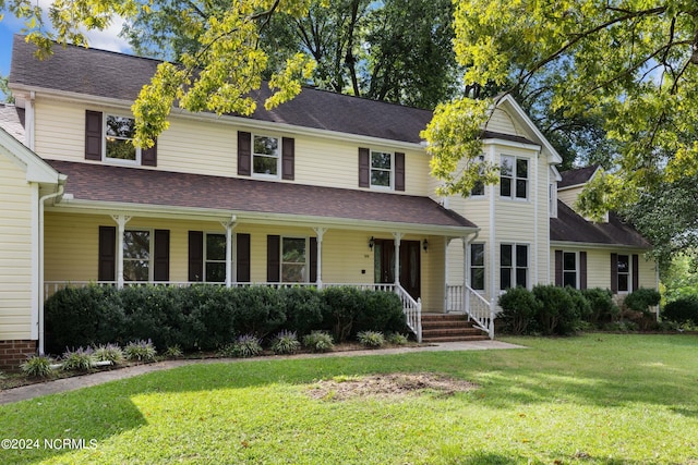 view of front of house with covered porch and a front yard