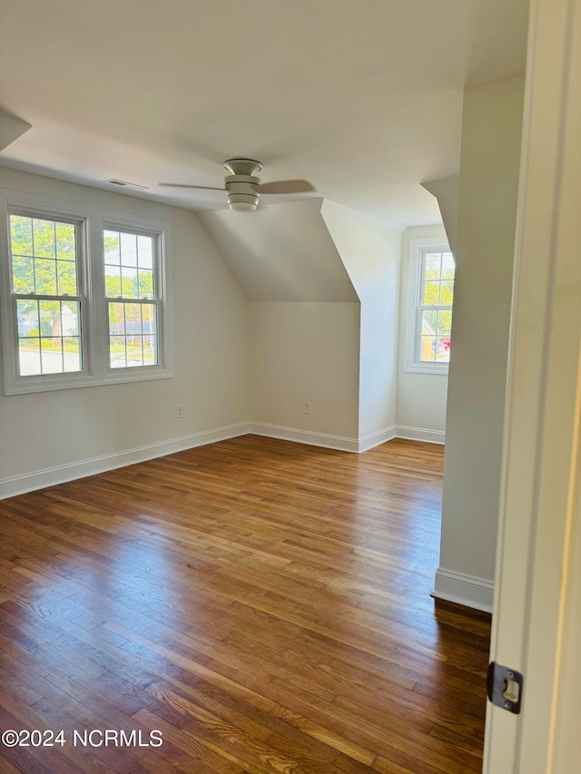 bonus room with dark hardwood / wood-style floors, vaulted ceiling, and ceiling fan