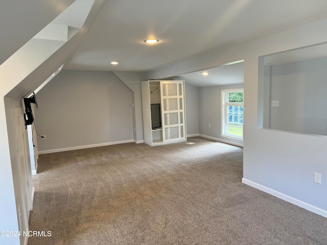 additional living space with carpet and vaulted ceiling