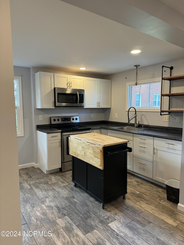 403 Main St, Bayboro, NC 28515 - kitchen featuring stainless steel appliances, a sink, healthy amount of natural light, white cabinets, and recessed lighting
