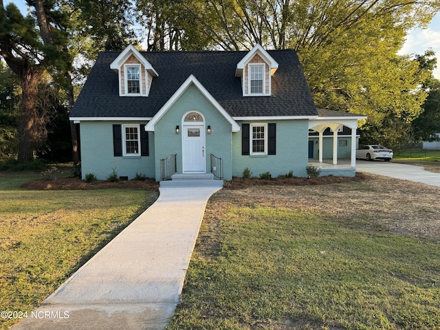 cape cod-style house with a front yard