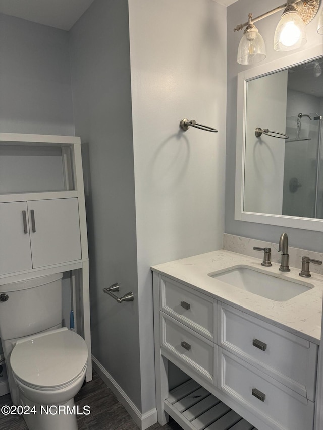 403 Main St, Bayboro, NC 28515 - bathroom with toilet, vanity, baseboards, wood finished floors, and a shower