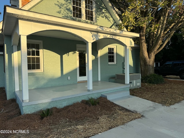 view of exterior entry featuring a porch