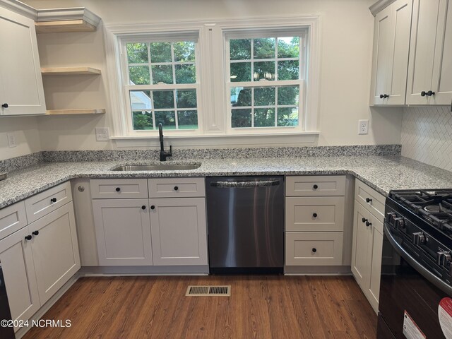 kitchen with dishwasher, sink, a wealth of natural light, and dark hardwood / wood-style flooring