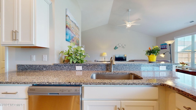 kitchen with dishwasher, sink, and light stone countertops