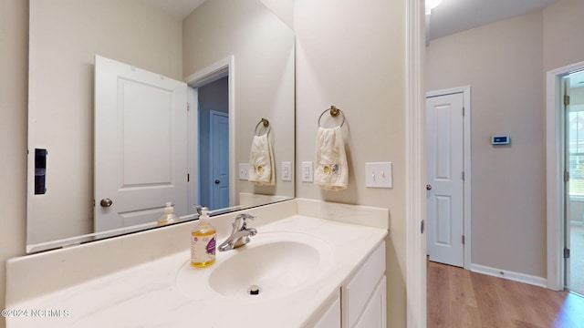 bathroom featuring hardwood / wood-style flooring and vanity