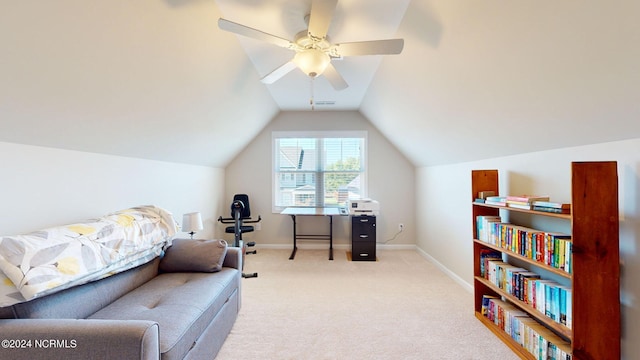 living area featuring ceiling fan, light colored carpet, and vaulted ceiling