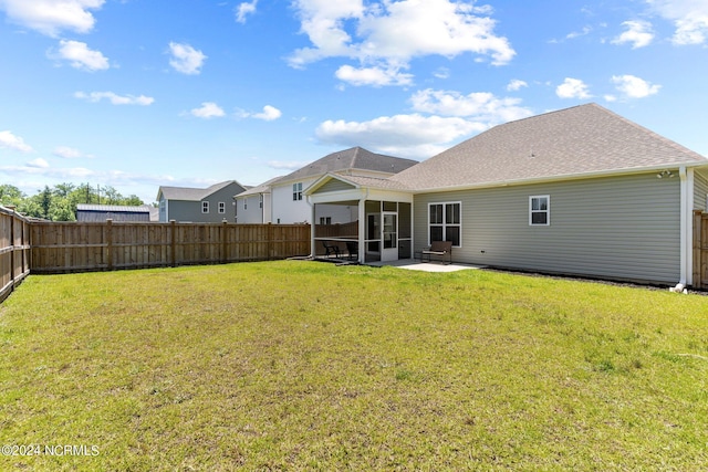 back of property featuring a patio, a sunroom, and a yard