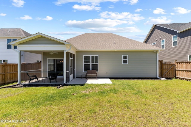 back of house with ceiling fan, a patio, and a lawn