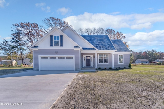 view of front of property with a garage and a front lawn