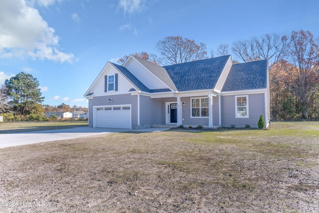 view of front of home with a garage and a front lawn