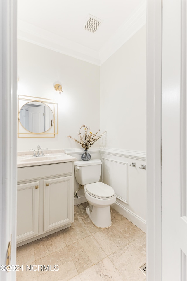 bathroom featuring ornamental molding, toilet, and vanity