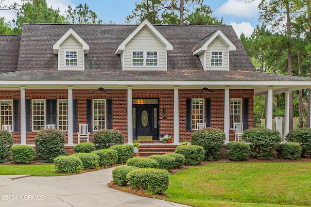 view of front of home featuring covered porch and a front yard