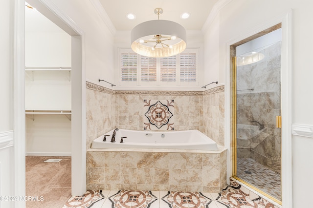 bathroom with ornamental molding and separate shower and tub