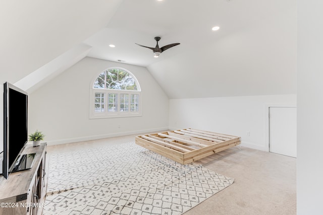 additional living space with light carpet, lofted ceiling, and ceiling fan