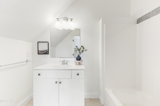 bathroom with shower / bathtub combination, lofted ceiling, vanity, and tile patterned flooring