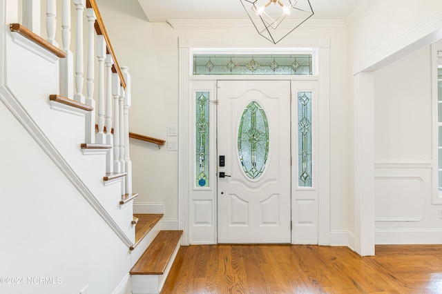 entryway featuring ornamental molding and hardwood / wood-style floors