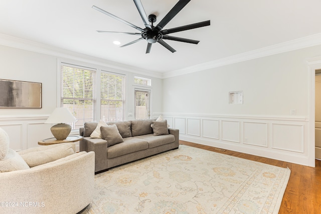 living room with ornamental molding, hardwood / wood-style floors, and ceiling fan