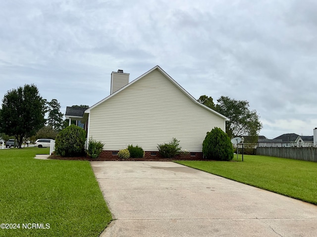 view of property exterior with a yard