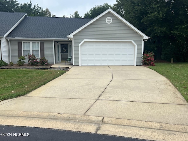 view of front of property with a garage and a front yard