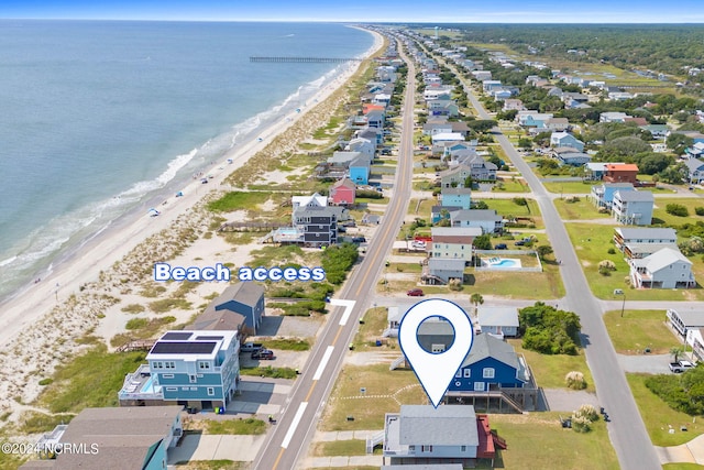 bird's eye view with a water view and a view of the beach