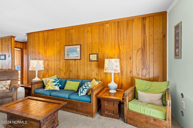 living room featuring light carpet, wooden walls, and crown molding