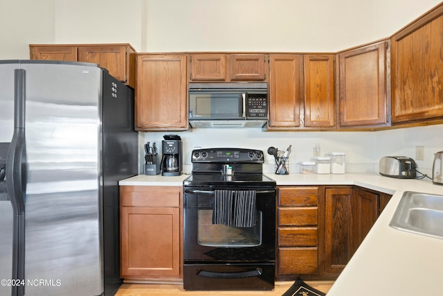 kitchen with black appliances and sink