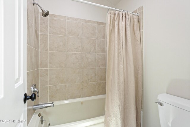 bathroom with toilet and shower / tub combo