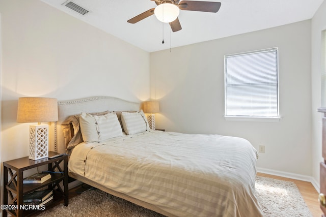 bedroom with hardwood / wood-style flooring and ceiling fan