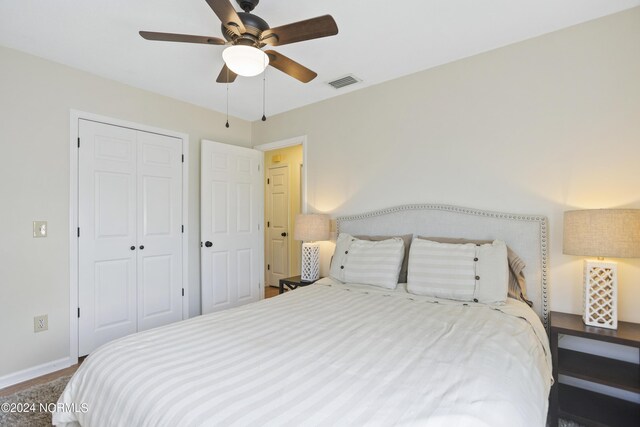 bedroom featuring ceiling fan and a closet