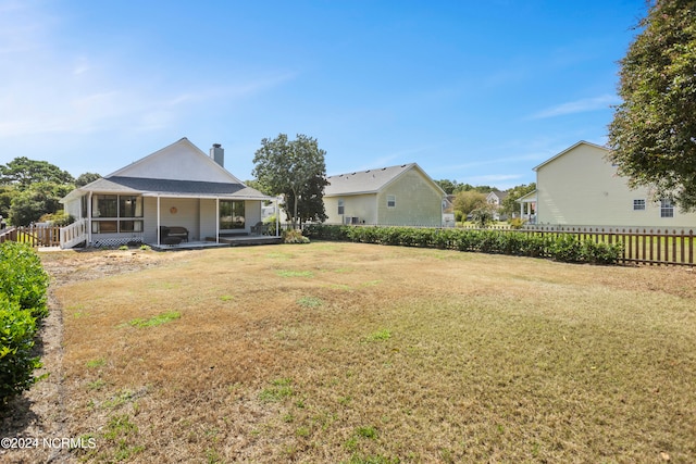 view of yard featuring a sunroom