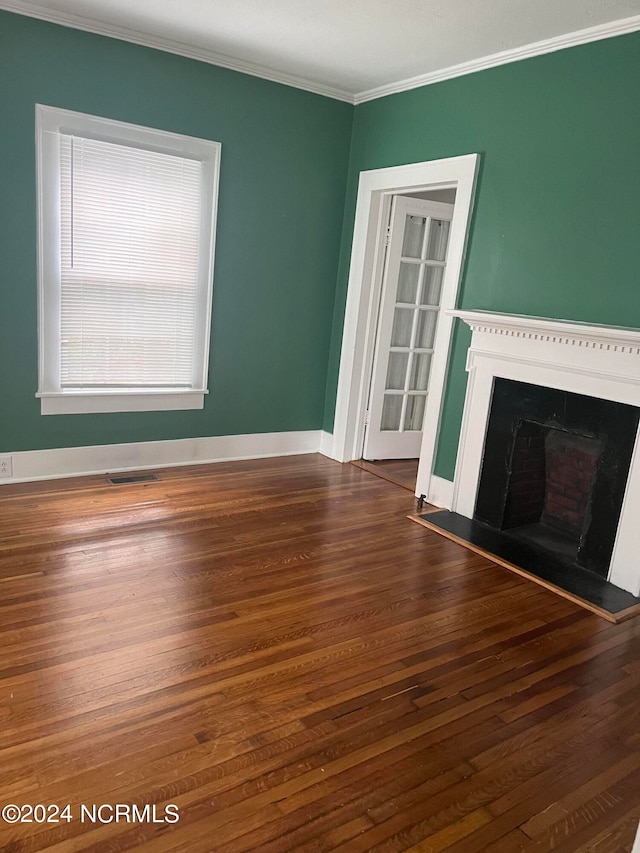 unfurnished living room featuring dark hardwood / wood-style floors and ornamental molding