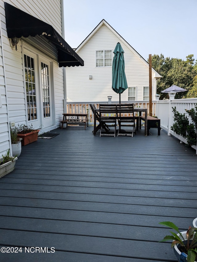 wooden deck with outdoor dining area