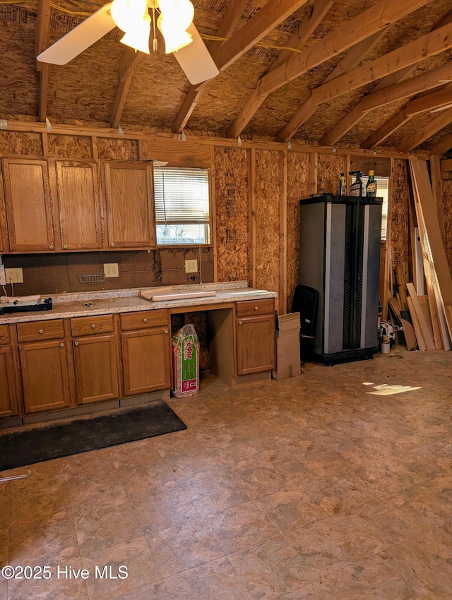 kitchen featuring brown cabinets, light countertops, and ceiling fan