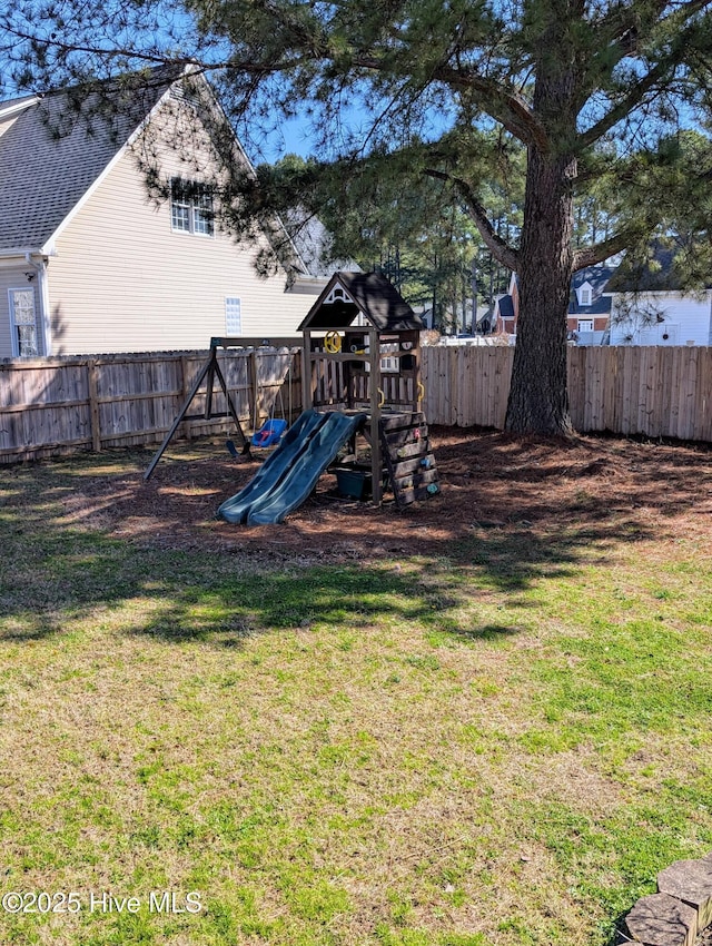 view of play area with a lawn and a fenced backyard