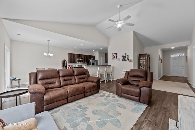 living room with high vaulted ceiling, ceiling fan with notable chandelier, and dark hardwood / wood-style flooring