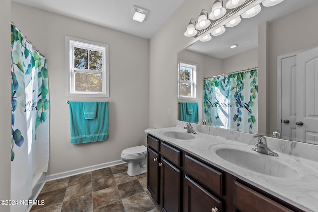 bathroom featuring a shower with curtain, vanity, and toilet