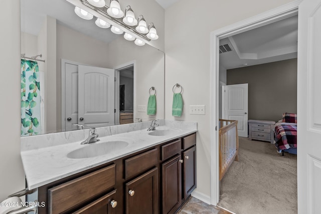 bathroom with a raised ceiling and vanity