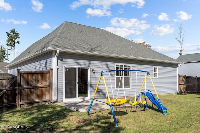 back of property featuring a lawn