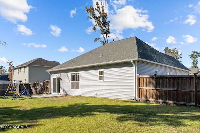 rear view of property featuring a lawn and a patio