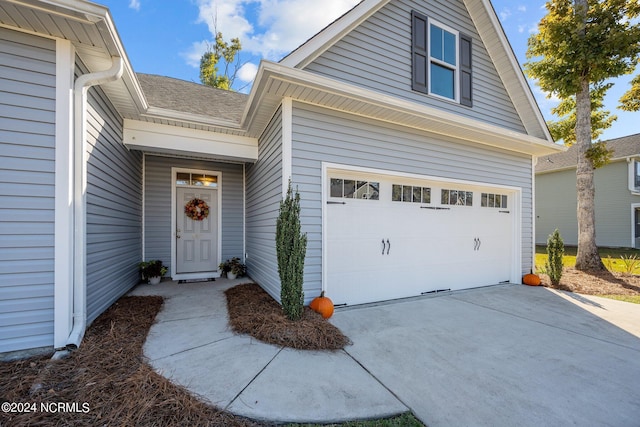 doorway to property with a garage