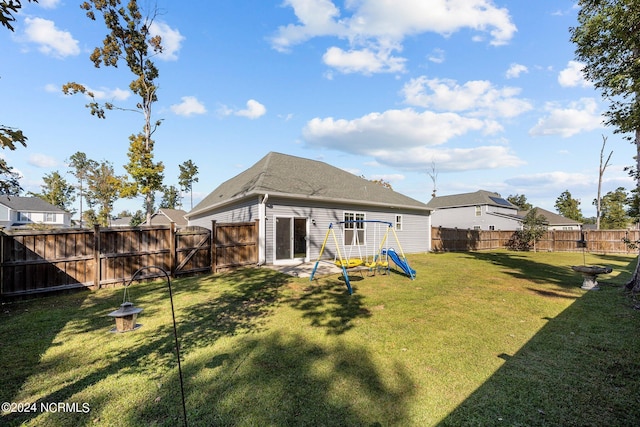 rear view of house with a yard