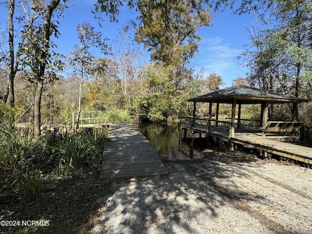 view of dock featuring a water view and a gazebo